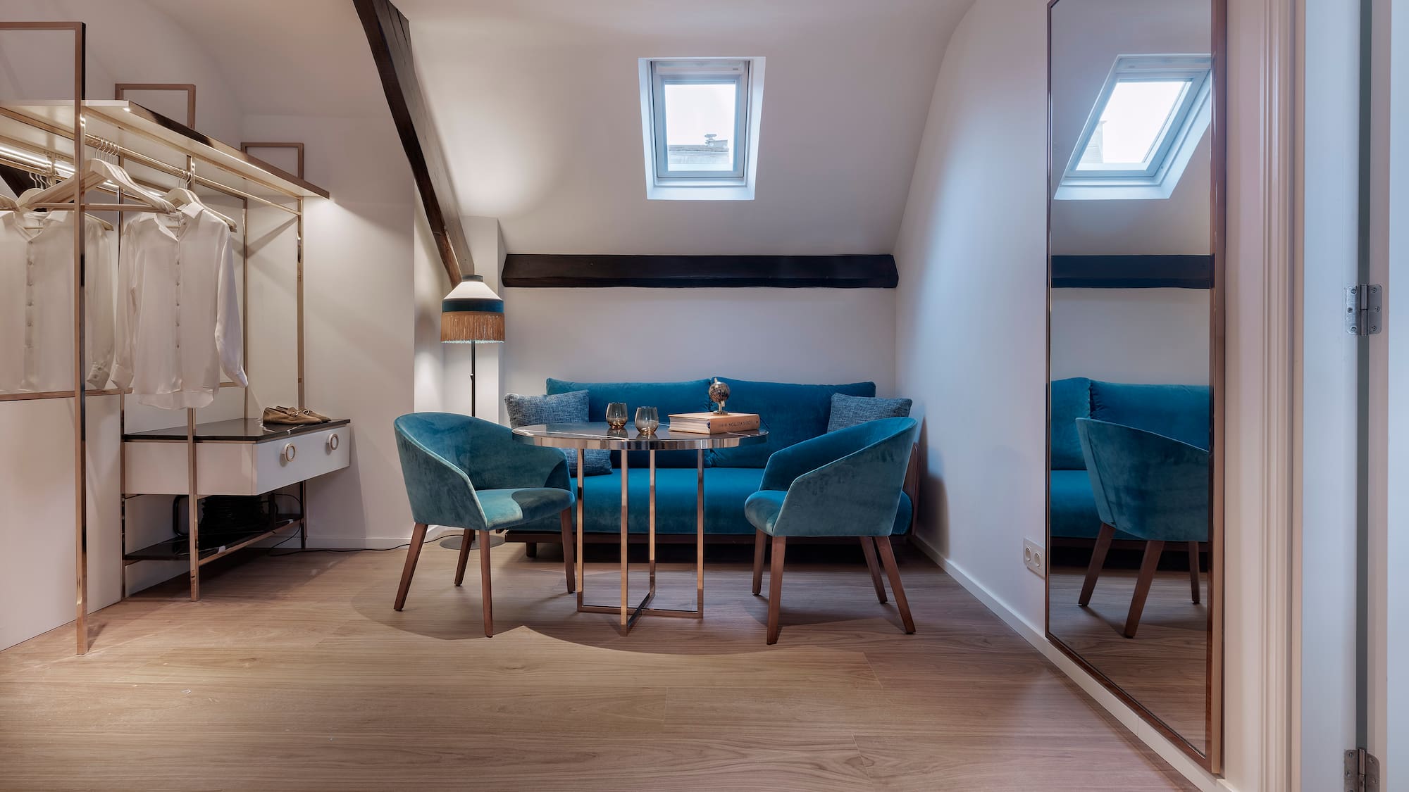 a room with a mirror and blue chairs