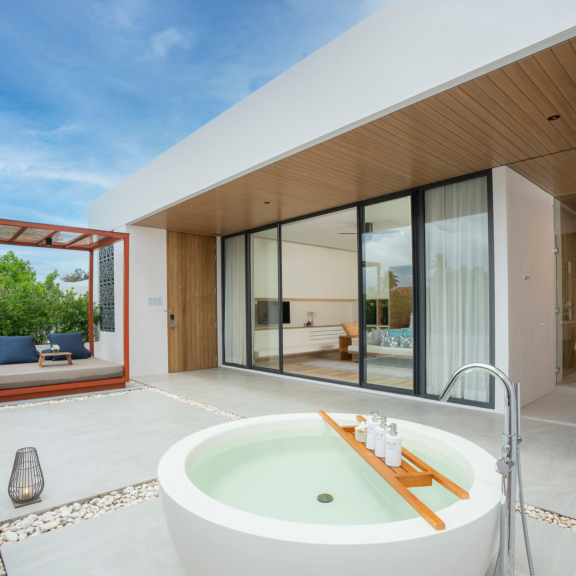 a white house with a tub and a patio