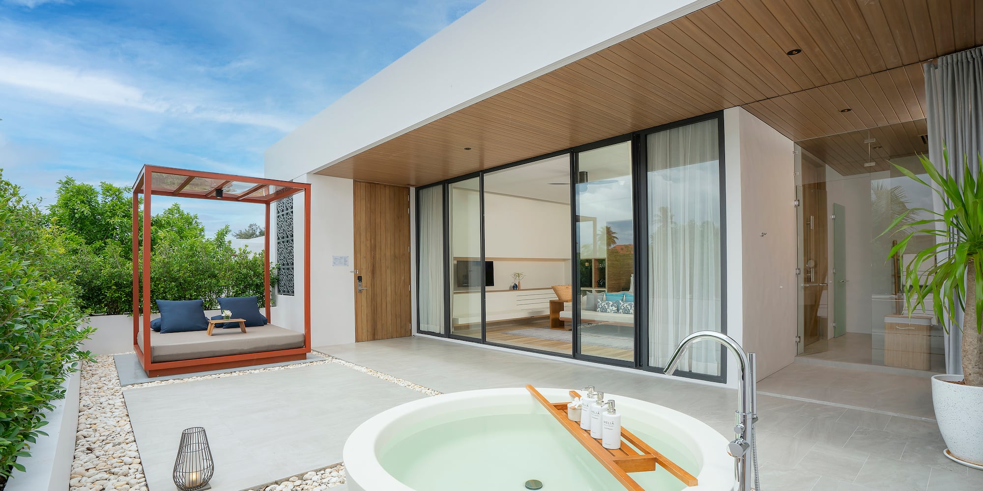 a white house with a tub and a patio