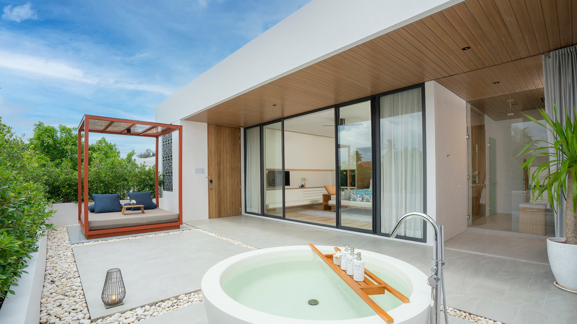 a white house with a tub and a patio