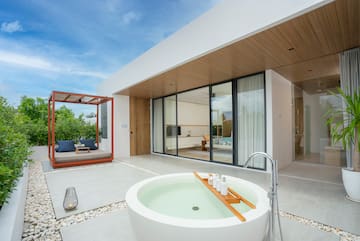 a white house with a tub and a patio