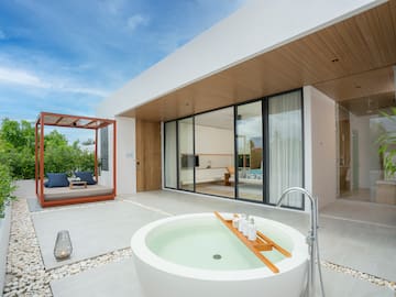 a white house with a tub and a patio