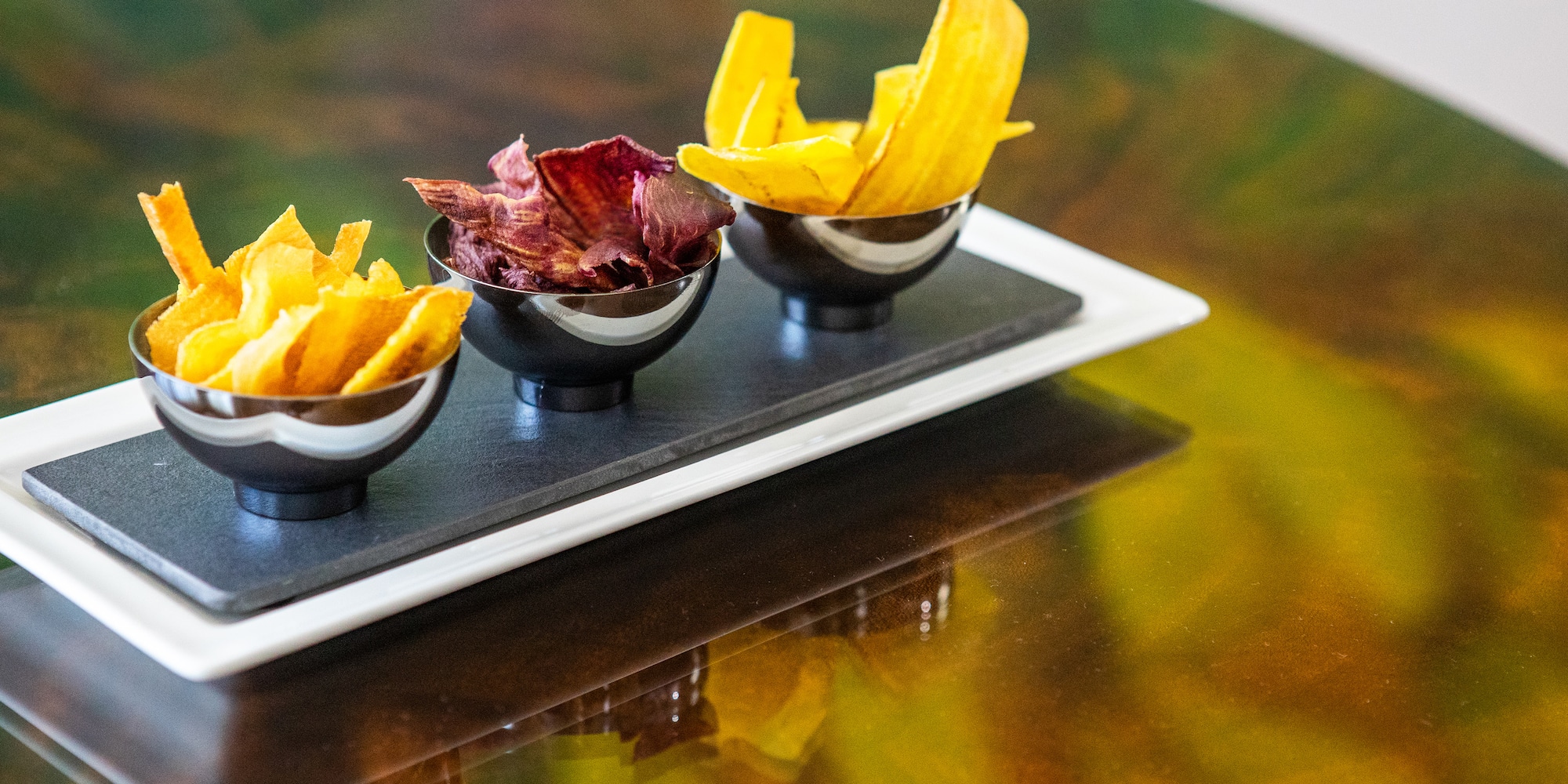 a group of bowls of chips on a table