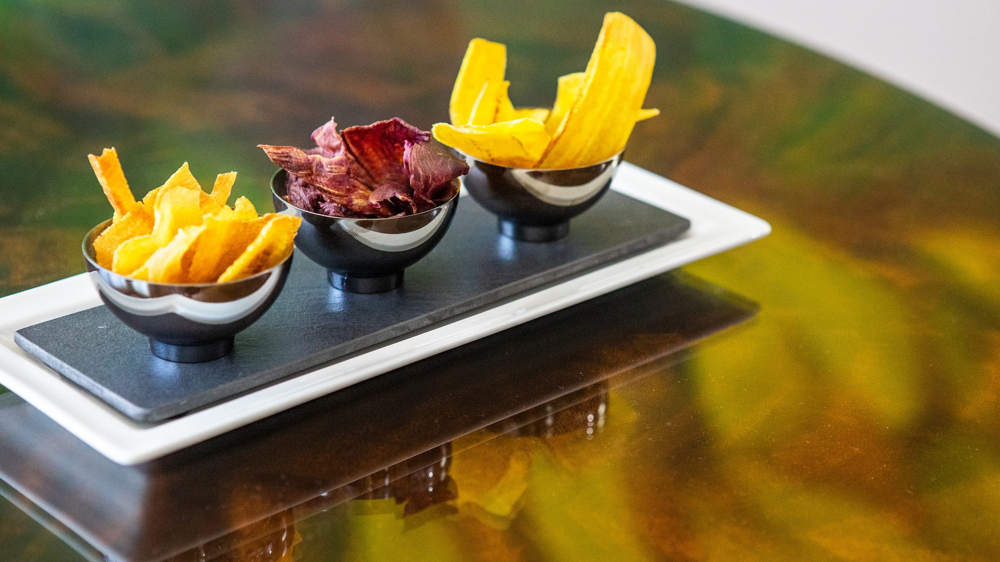 a group of bowls of chips on a table