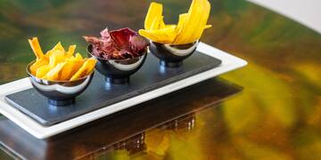 a group of bowls of chips on a table