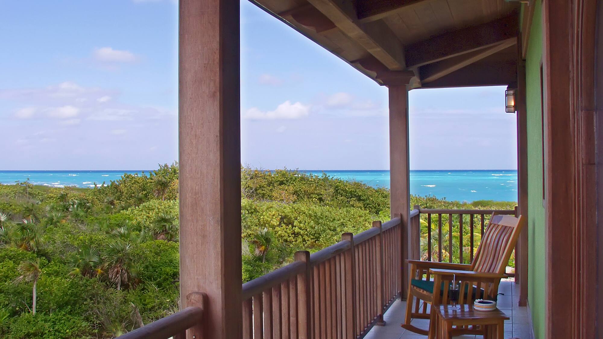 a deck with chairs and a table on it