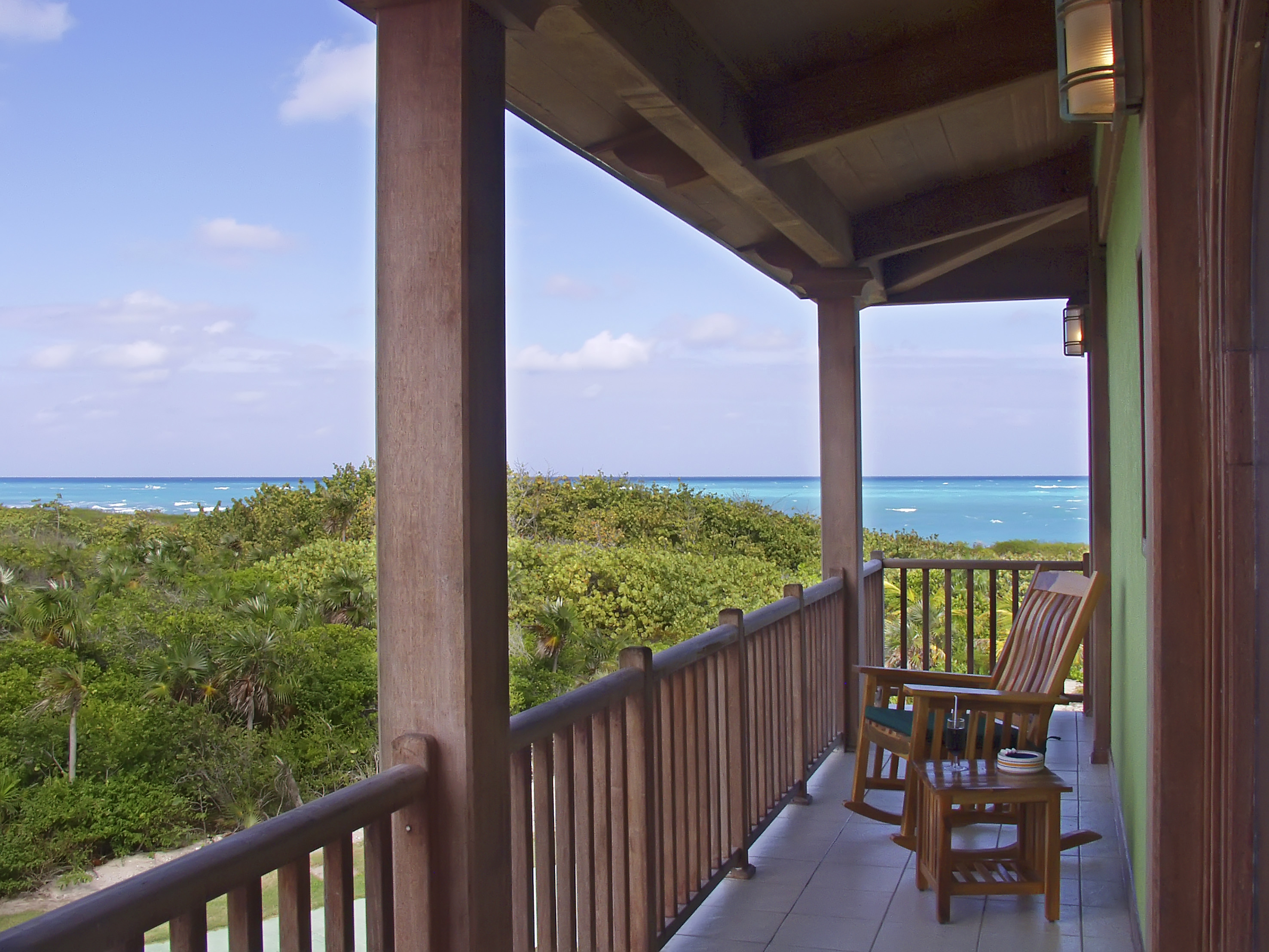 a deck with chairs and a table on it