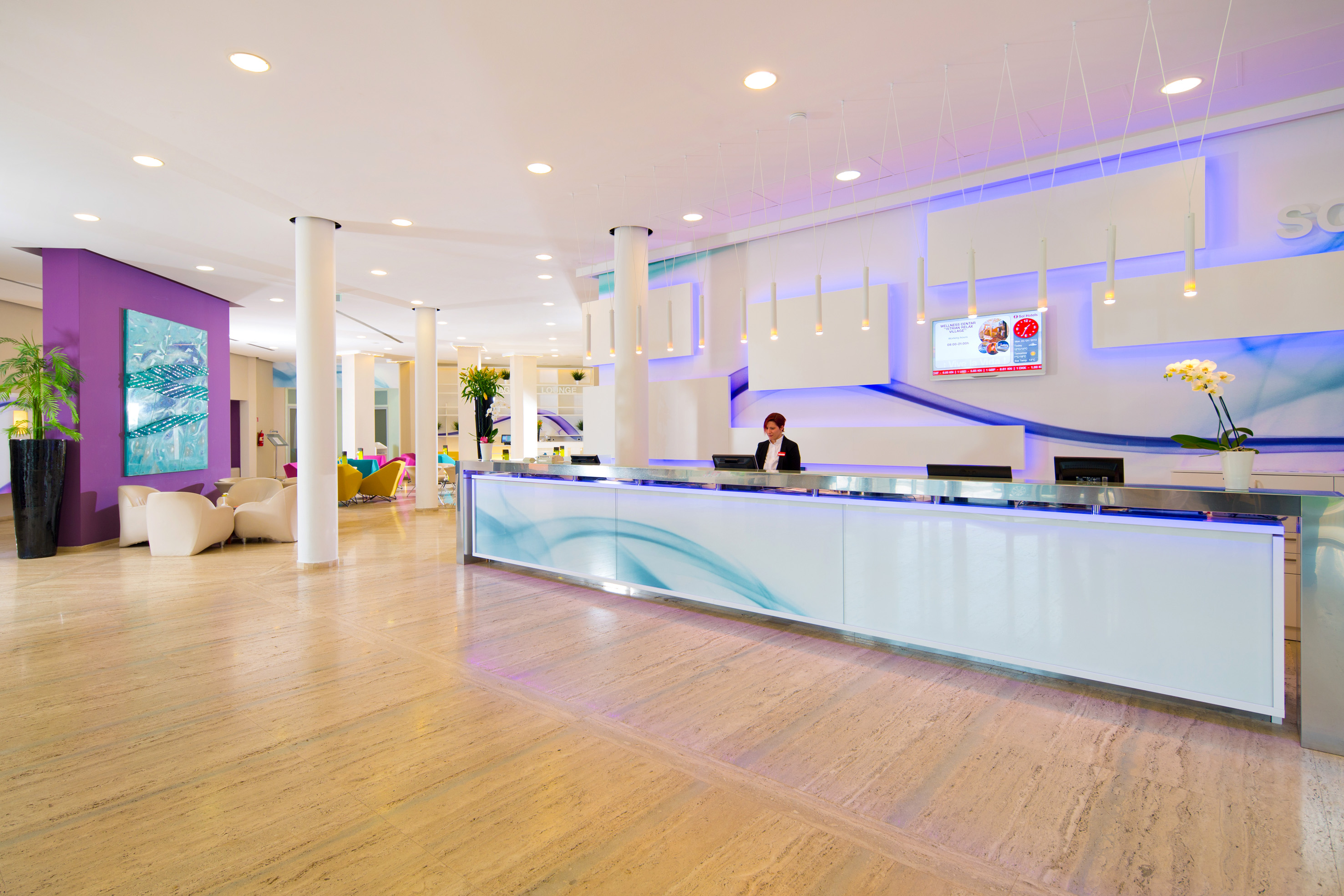 a woman standing at a reception desk