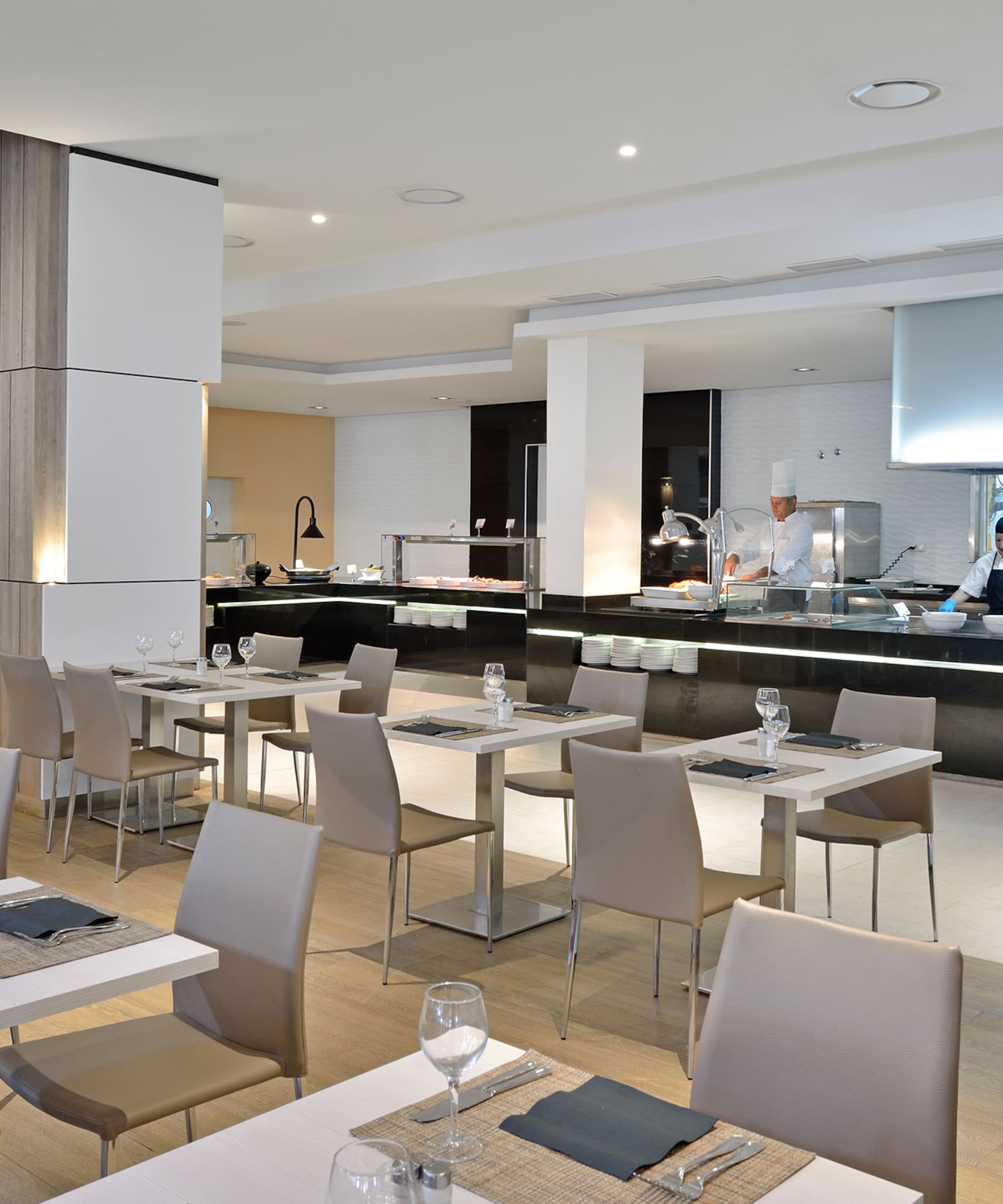 a restaurant with white tables and chairs