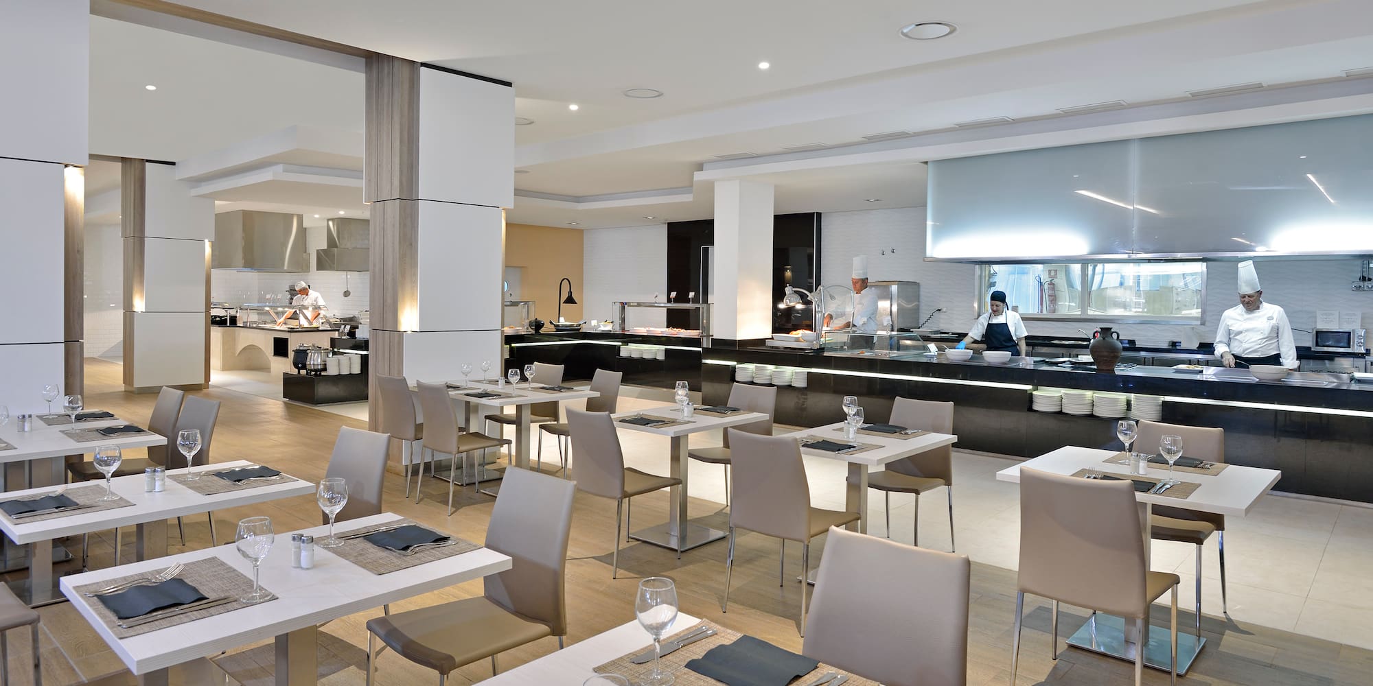 a restaurant with white tables and chairs