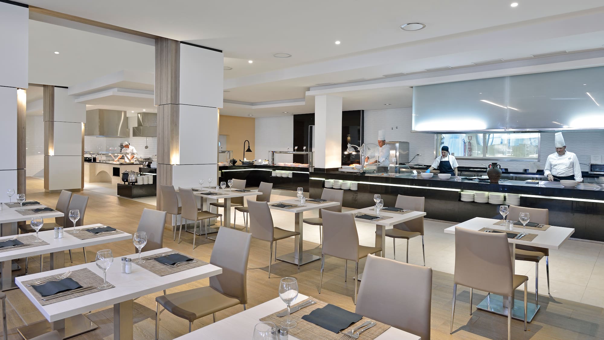 a restaurant with white tables and chairs