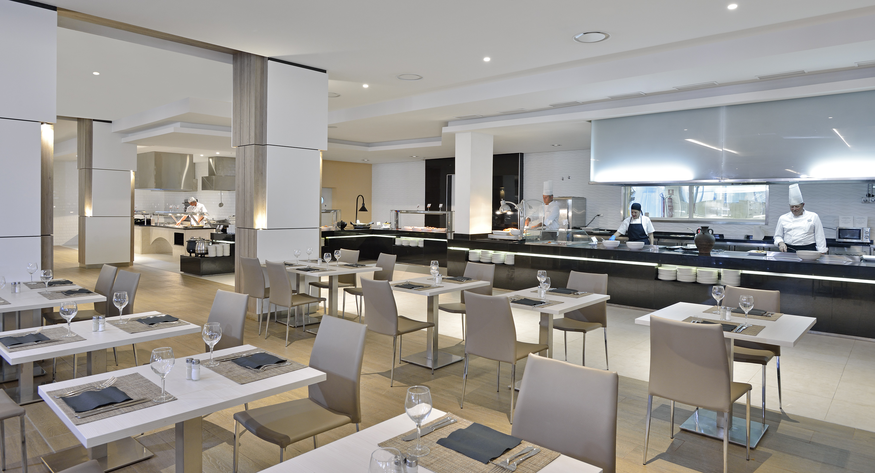 a restaurant with white tables and chairs