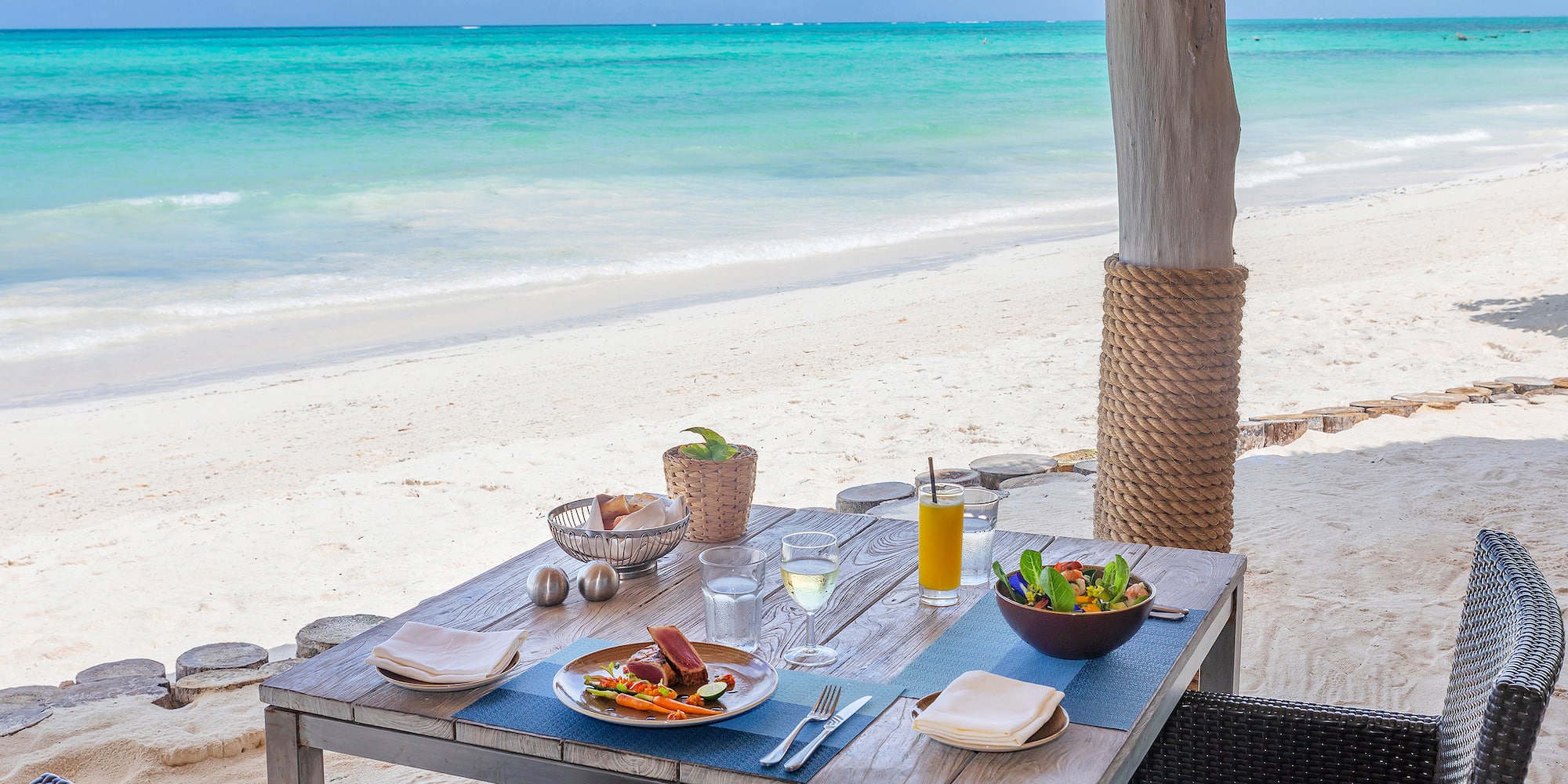 a table with food on it on a beach