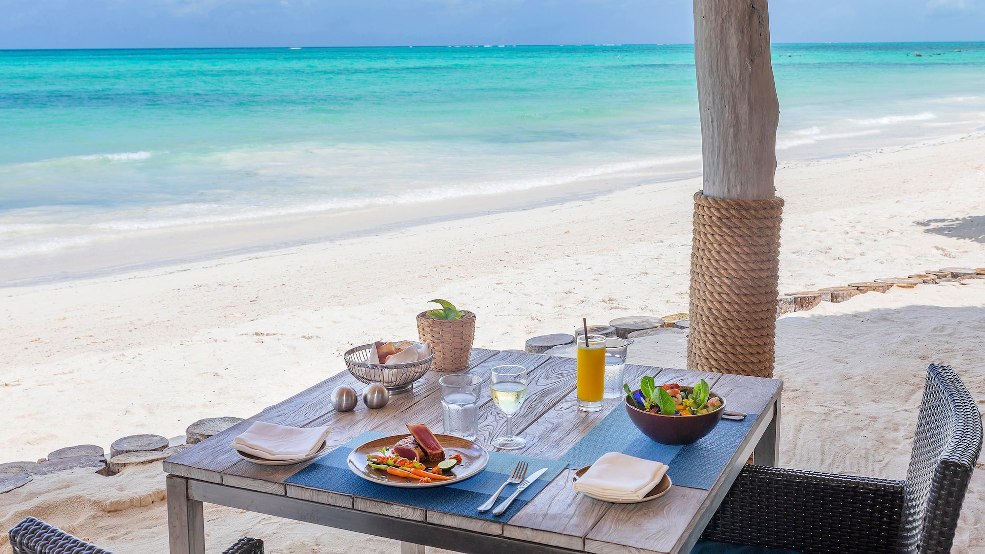 a table with food on it on a beach