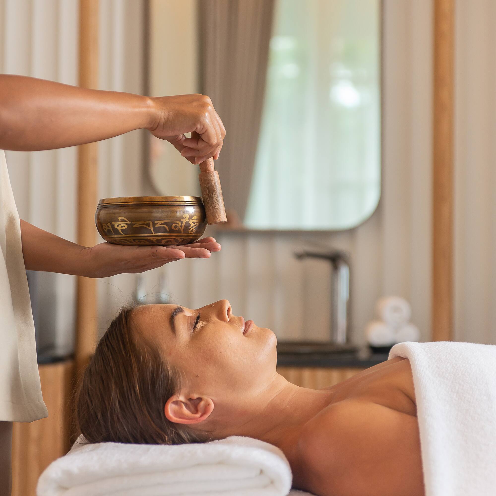 a person holding a bowl over a woman's face