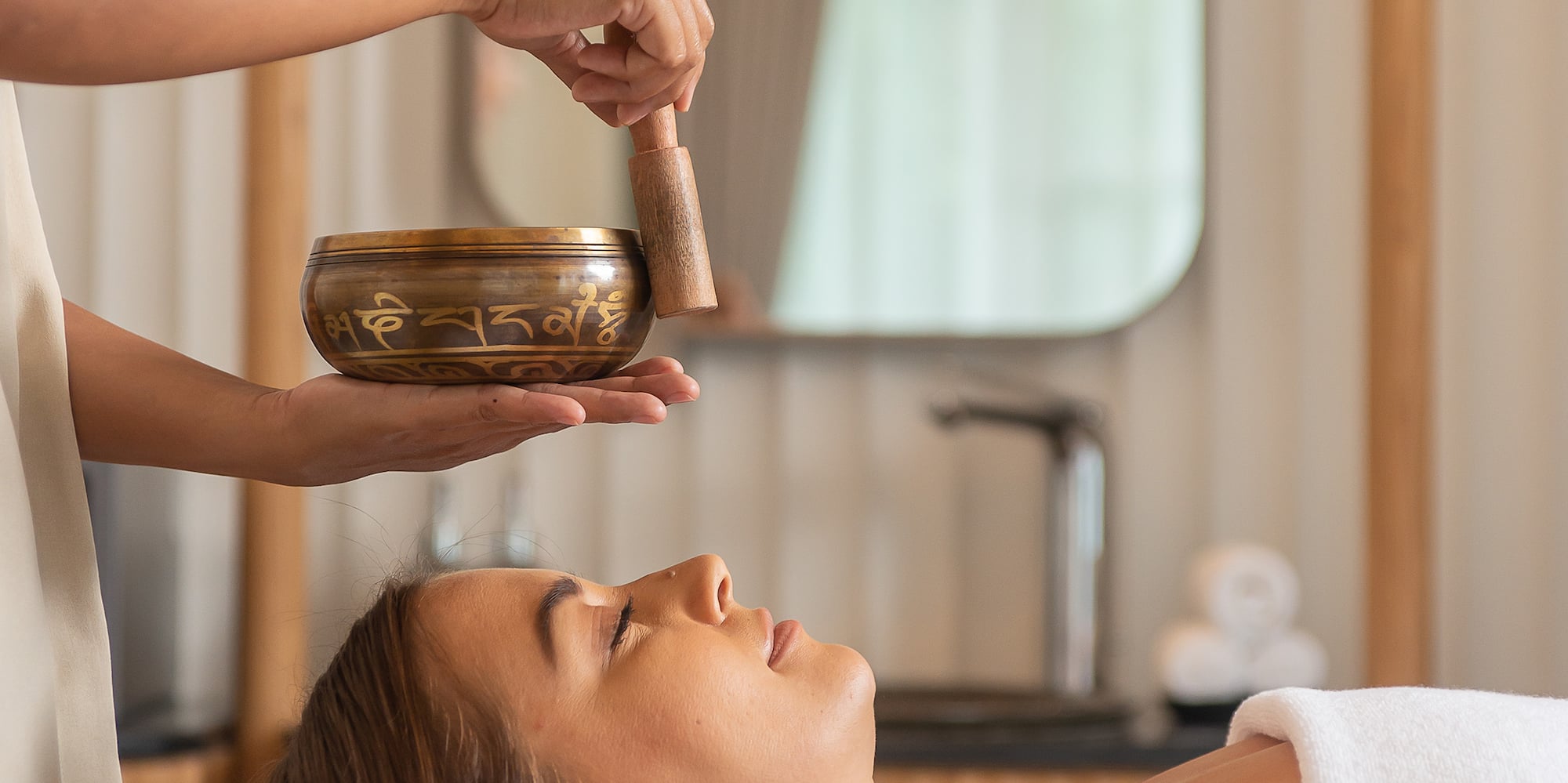 a person holding a bowl over a woman's face