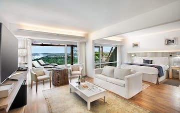 a room with a bed and chairs and a table