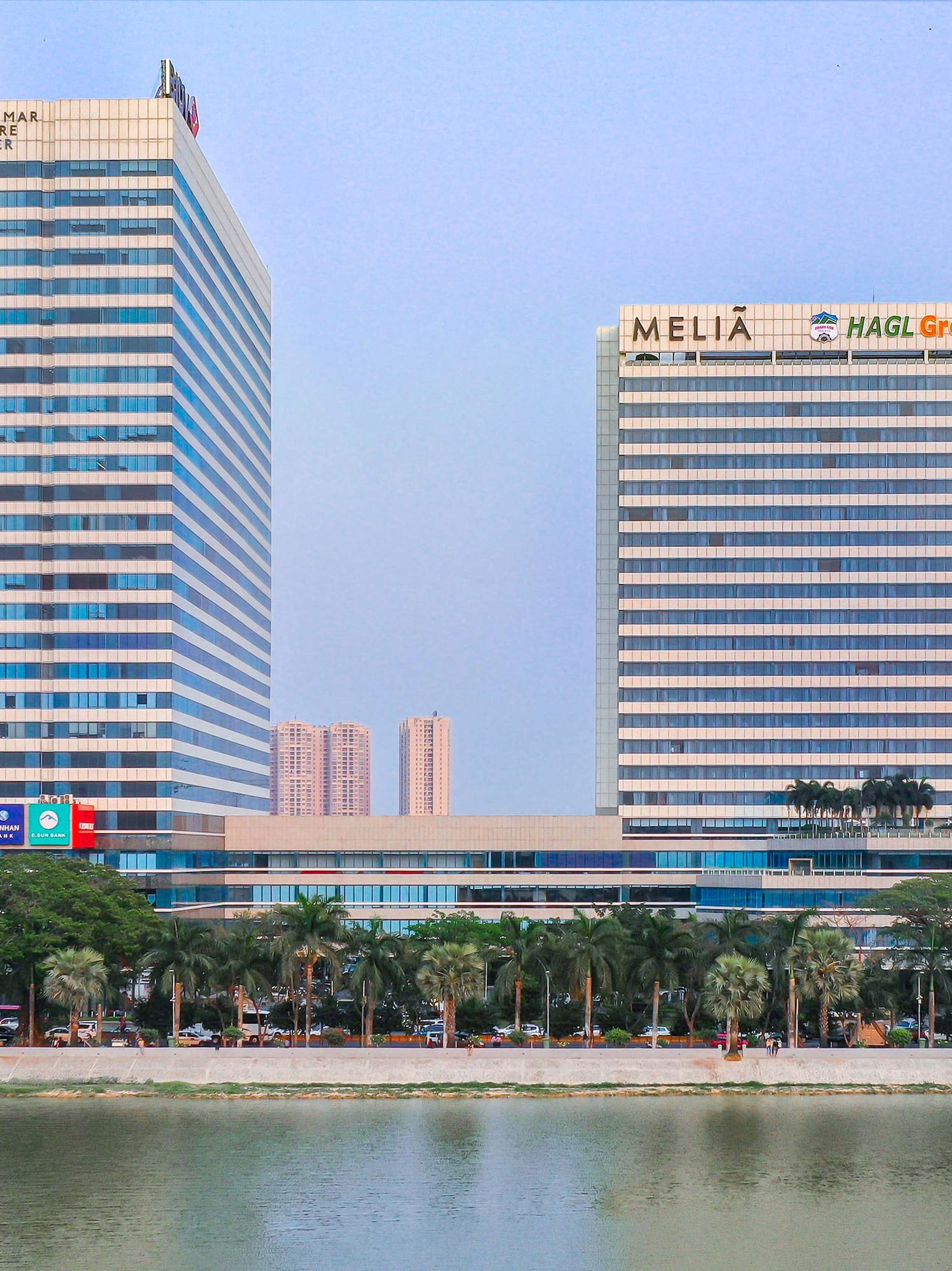 a group of tall buildings next to a body of water