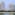 a group of tall buildings next to a body of water