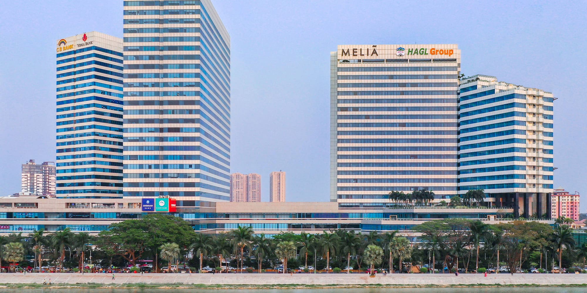 a group of tall buildings next to a body of water