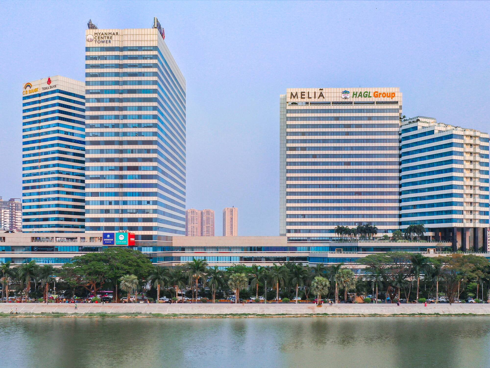 a group of tall buildings next to a body of water