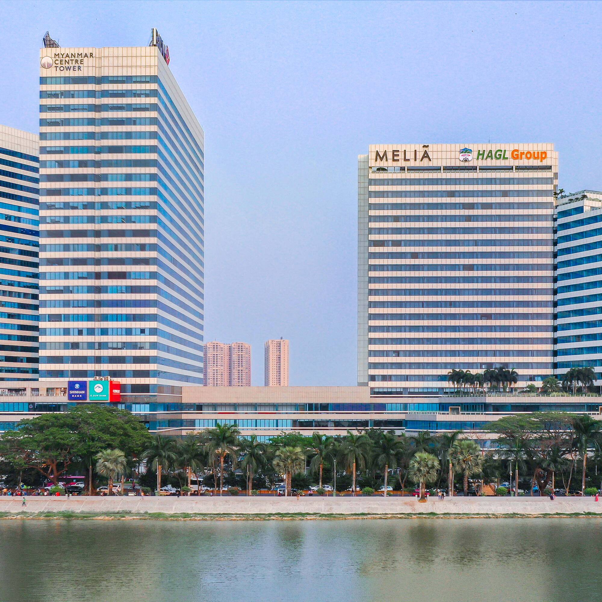 a group of tall buildings next to a body of water