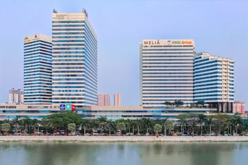 a group of tall buildings next to a body of water
