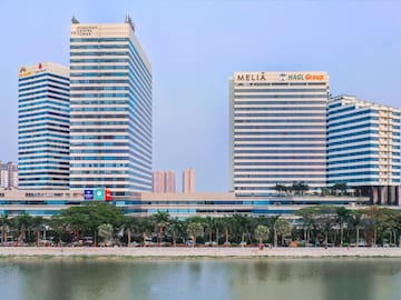a group of tall buildings next to a body of water