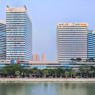 a group of tall buildings next to a body of water