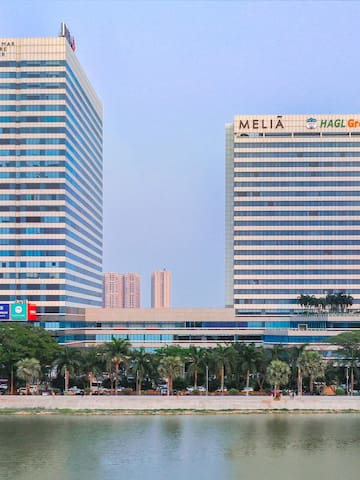 a group of tall buildings next to a body of water