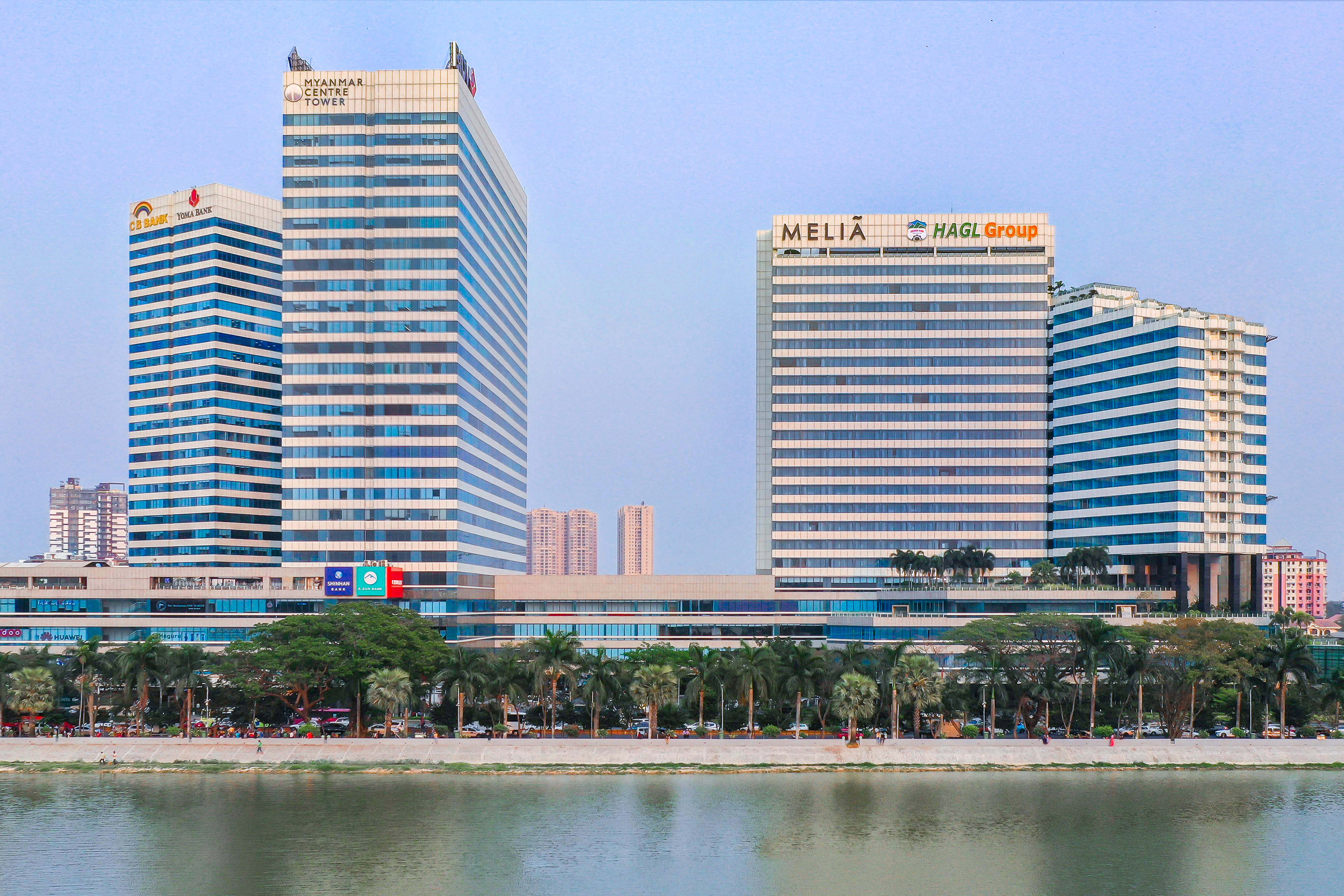 a group of tall buildings next to a body of water