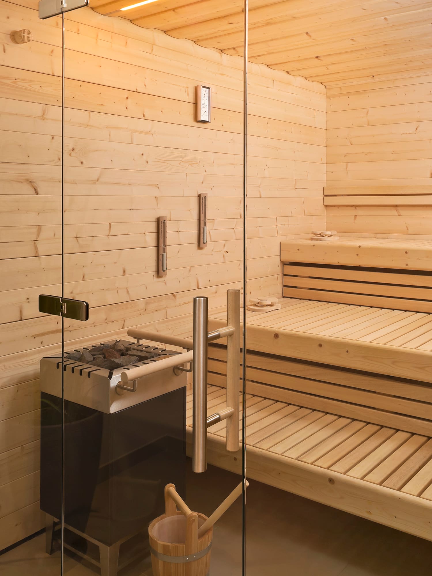 a sauna with a glass door