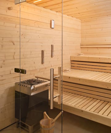 a sauna with a glass door