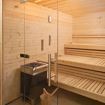 a sauna with a glass door