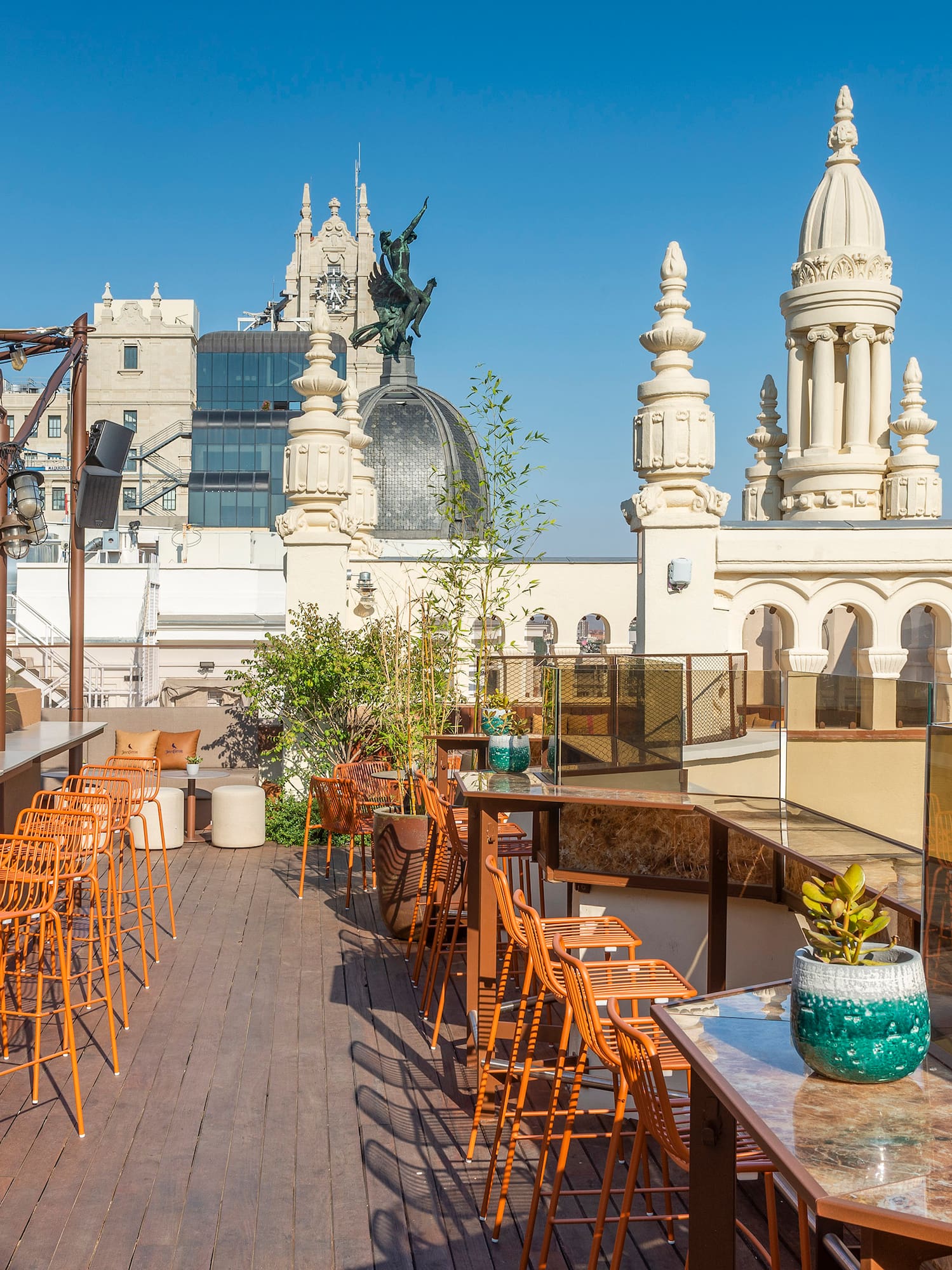 a rooftop bar with chairs and tables