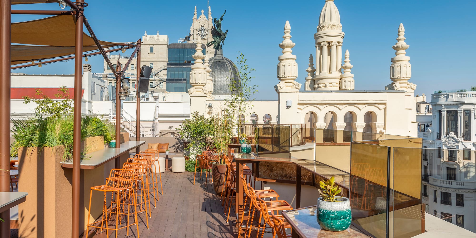 a rooftop bar with chairs and tables