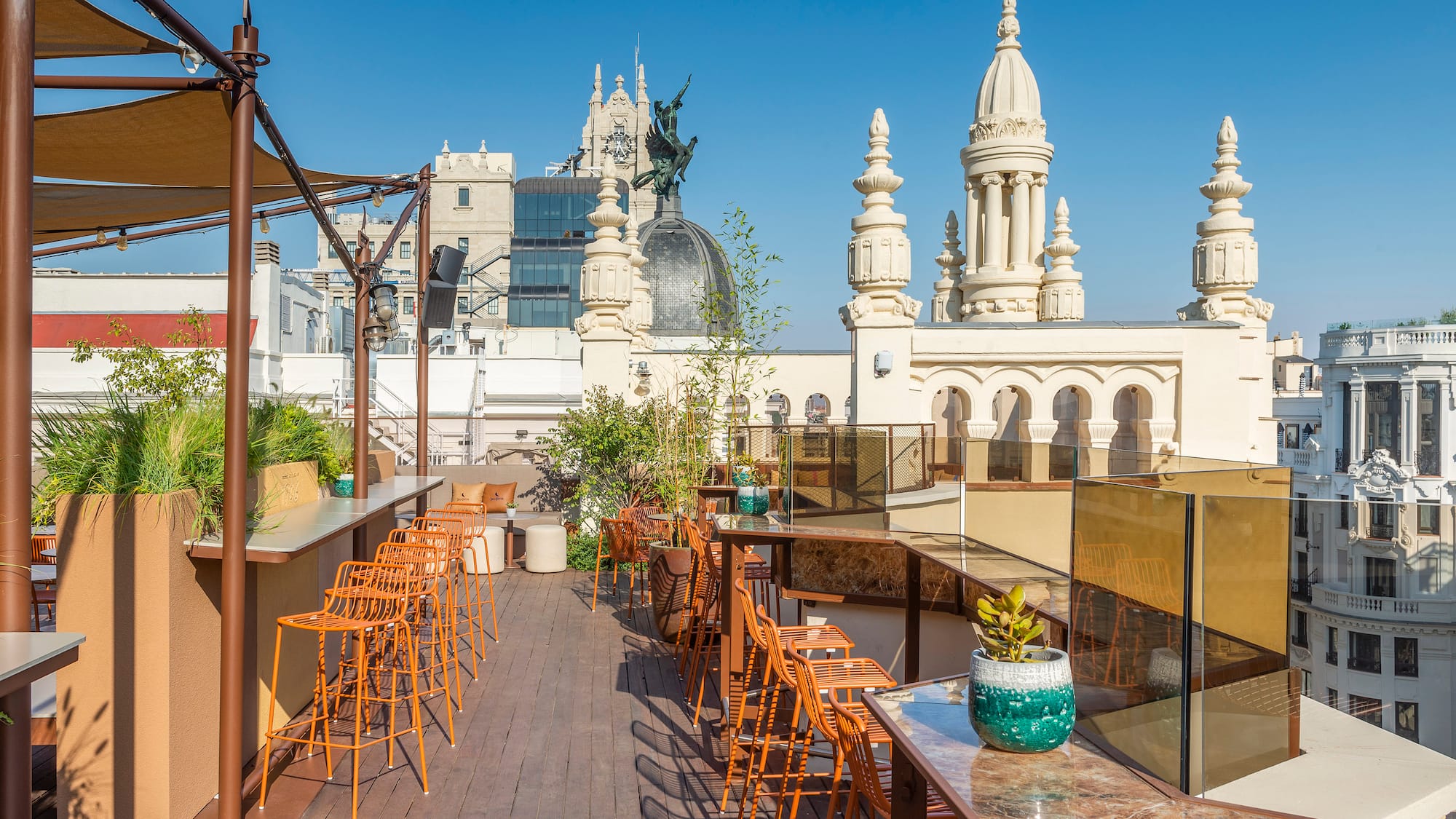 a rooftop bar with chairs and tables