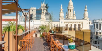 a rooftop bar with chairs and tables