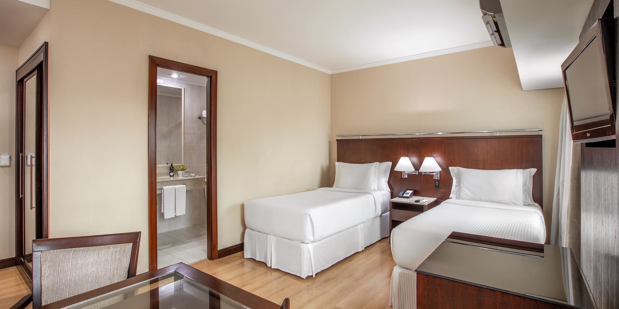 a room with two beds and a table