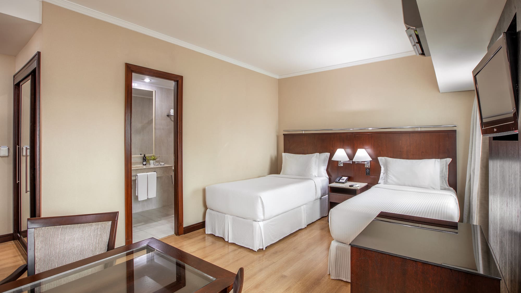 a room with two beds and a table