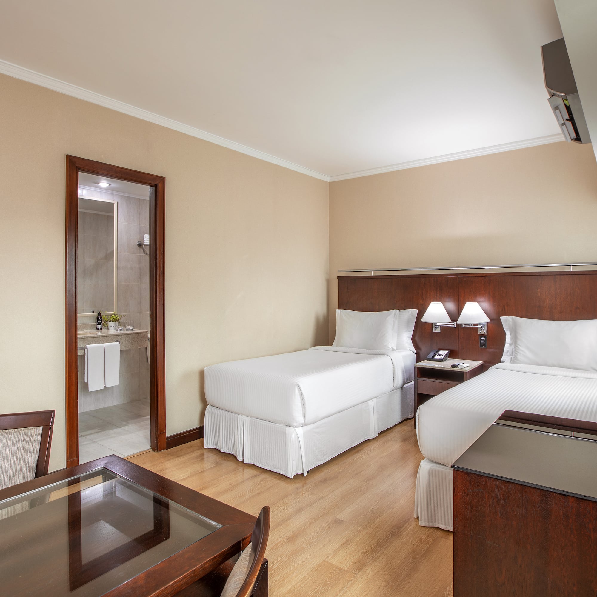 a room with two beds and a table