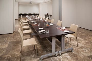 a long table with plates and utensils in a room