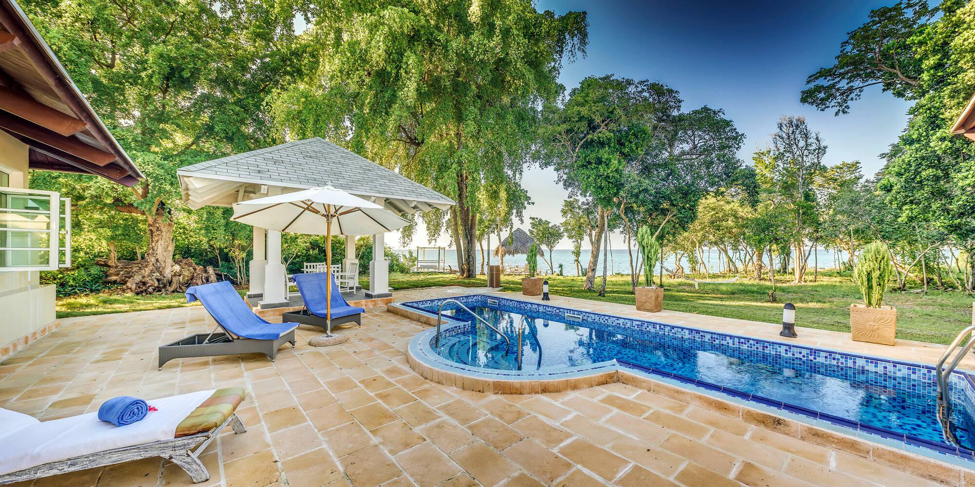 a pool with a deck chair and umbrella