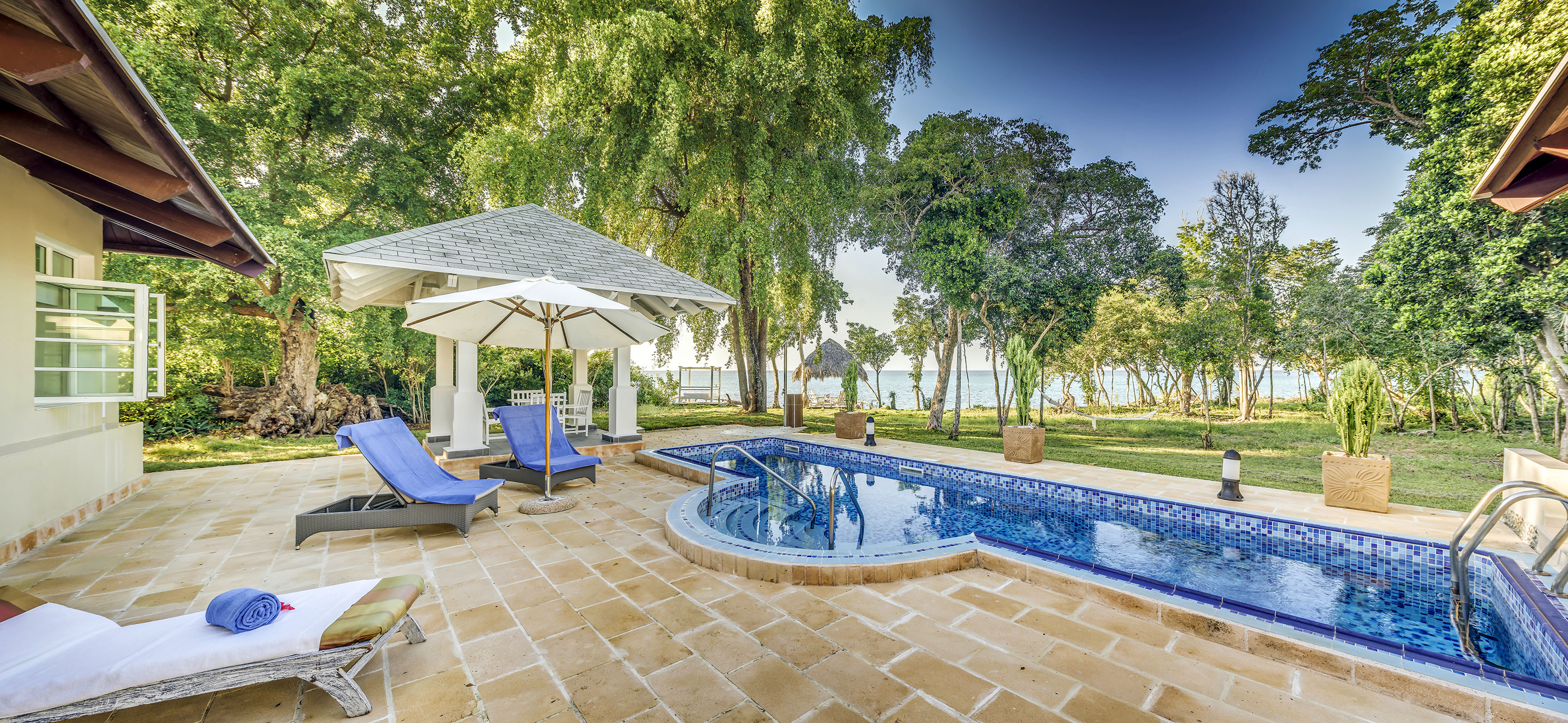a pool with a deck chair and umbrella