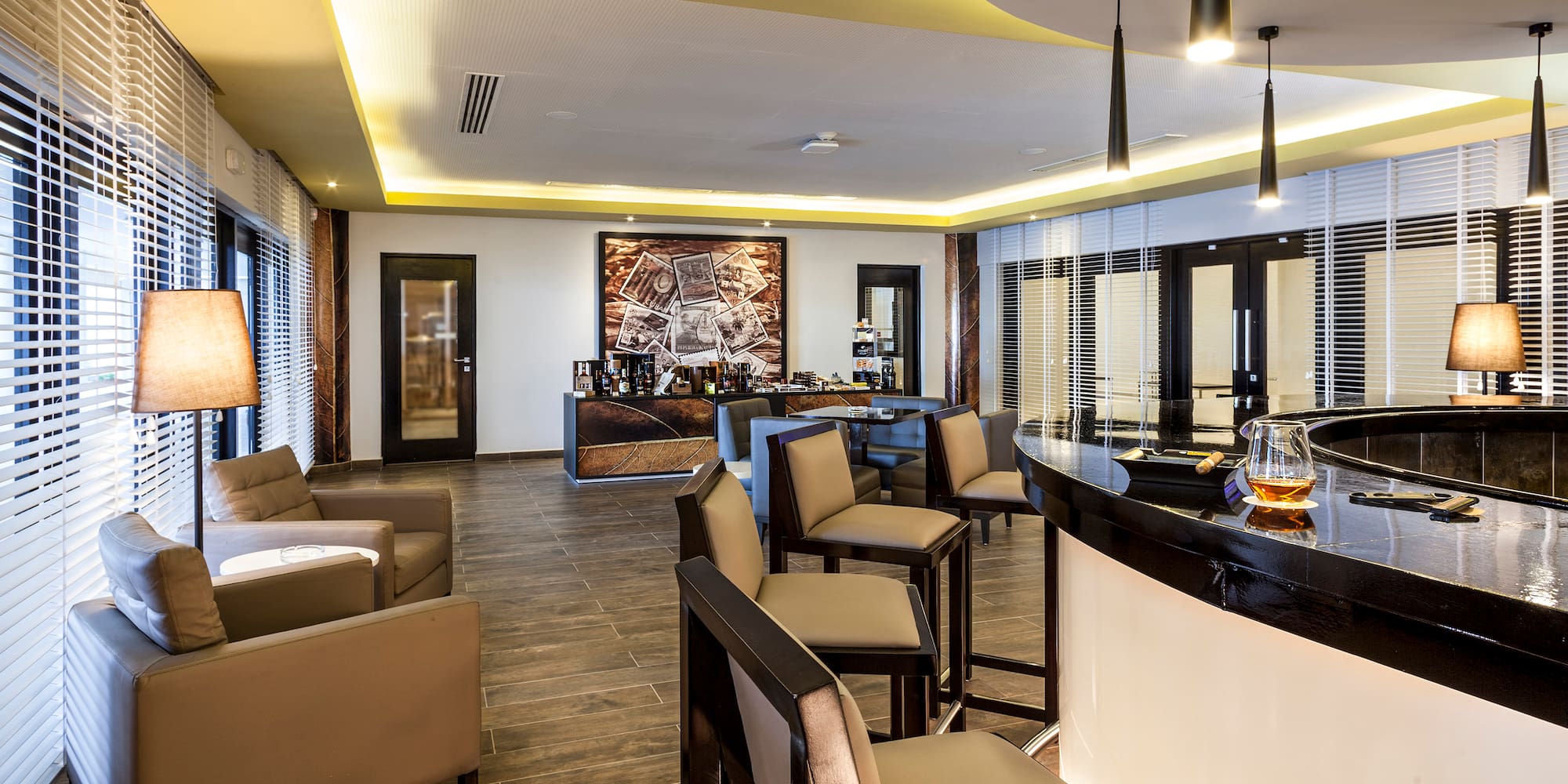 a room with a bar and chairs