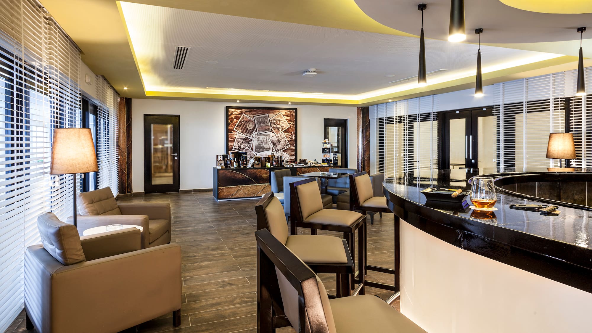 a room with a bar and chairs