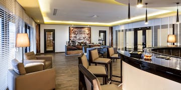 a room with a bar and chairs