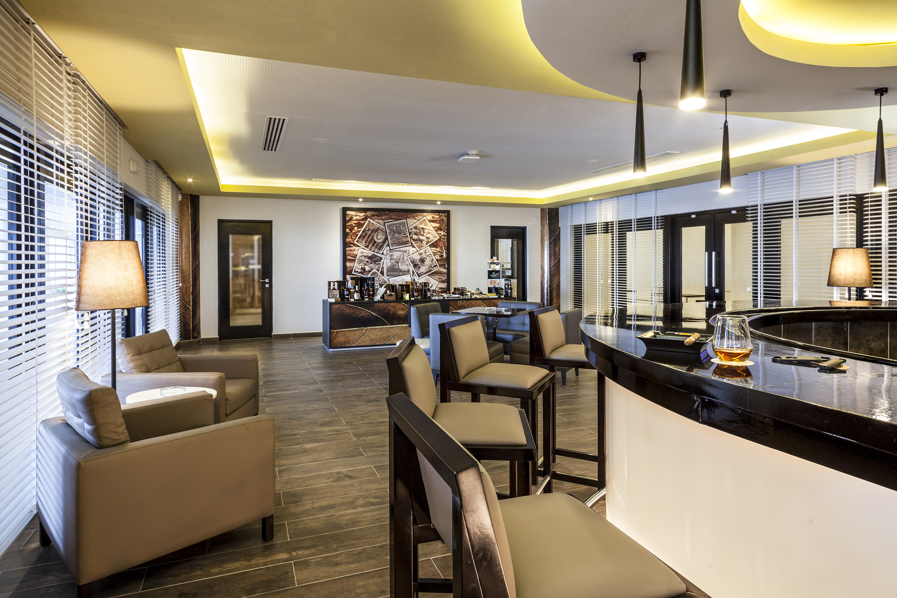 a room with a bar and chairs