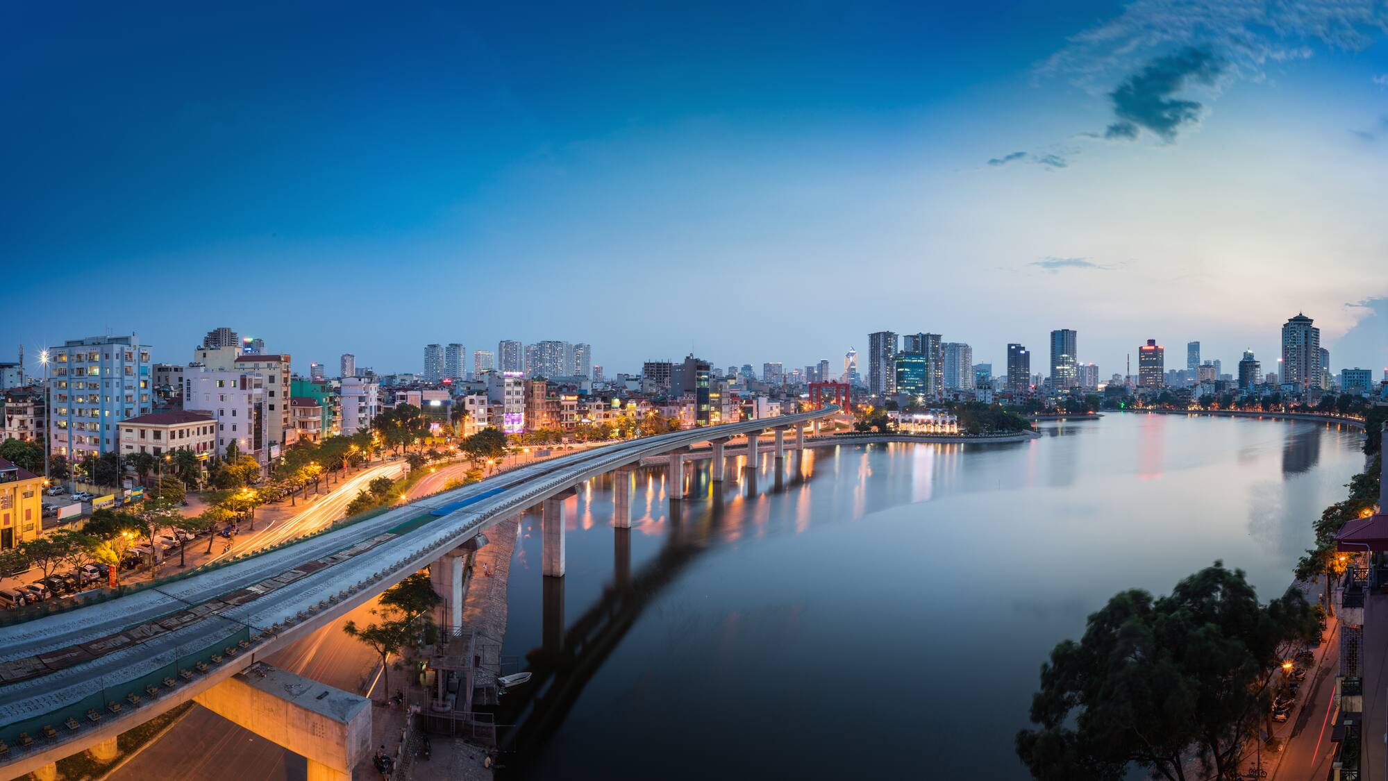 a bridge over a body of water with a city in the background