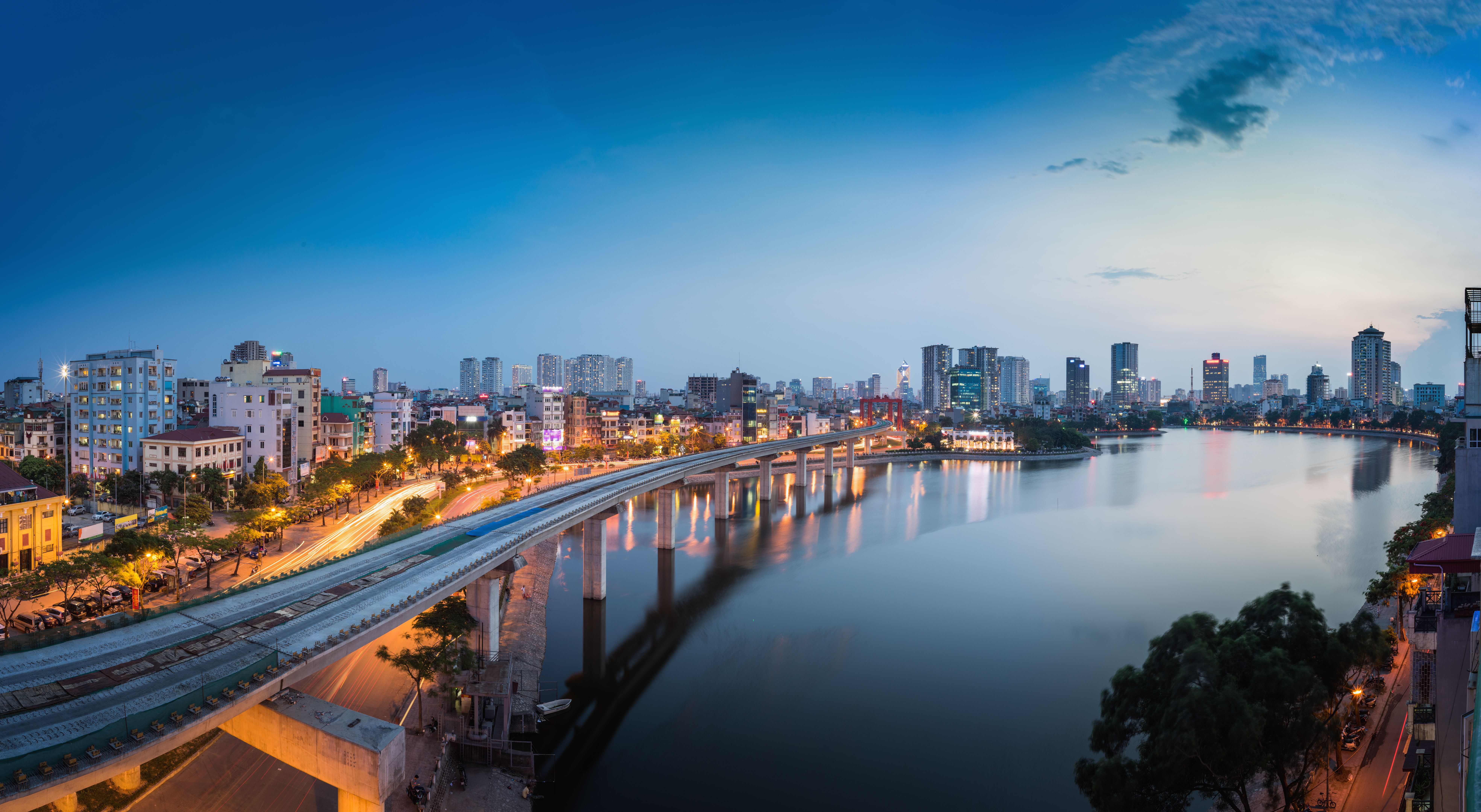a bridge over a body of water with a city in the background